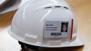 Contractor badge on a hard hat with drawings.