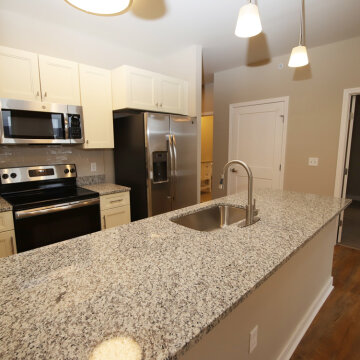 Kitchen within a one-bedroom unit in 100 West Water Apartments.